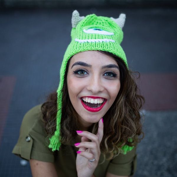 Smiling woman after a yoga session, looking refreshed and energetic.